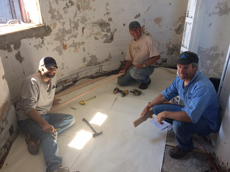 action floors volunteers installing hardwood floors