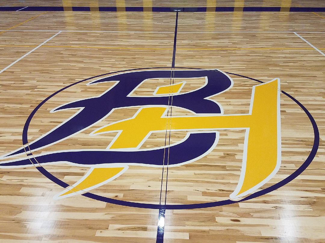 logo on hardwood gym floor with two colors